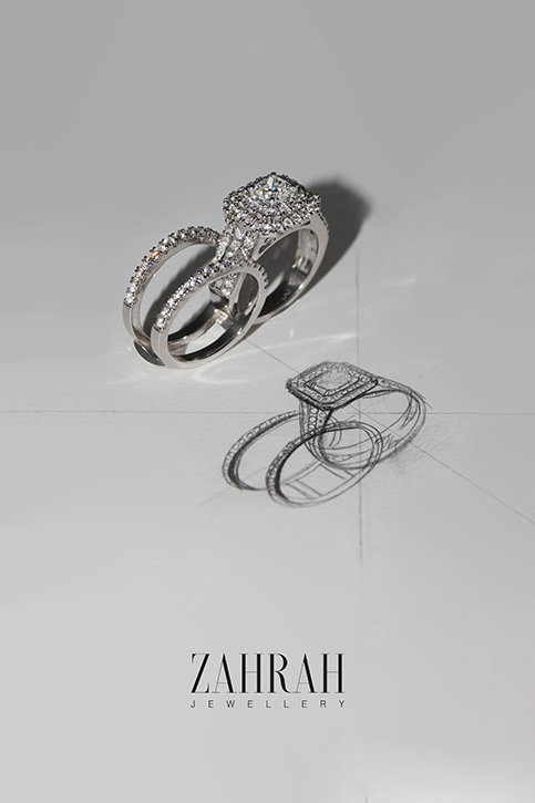 Image of connecting diamond rings placed on top of a white paper, with identical wedding bands sketched under.